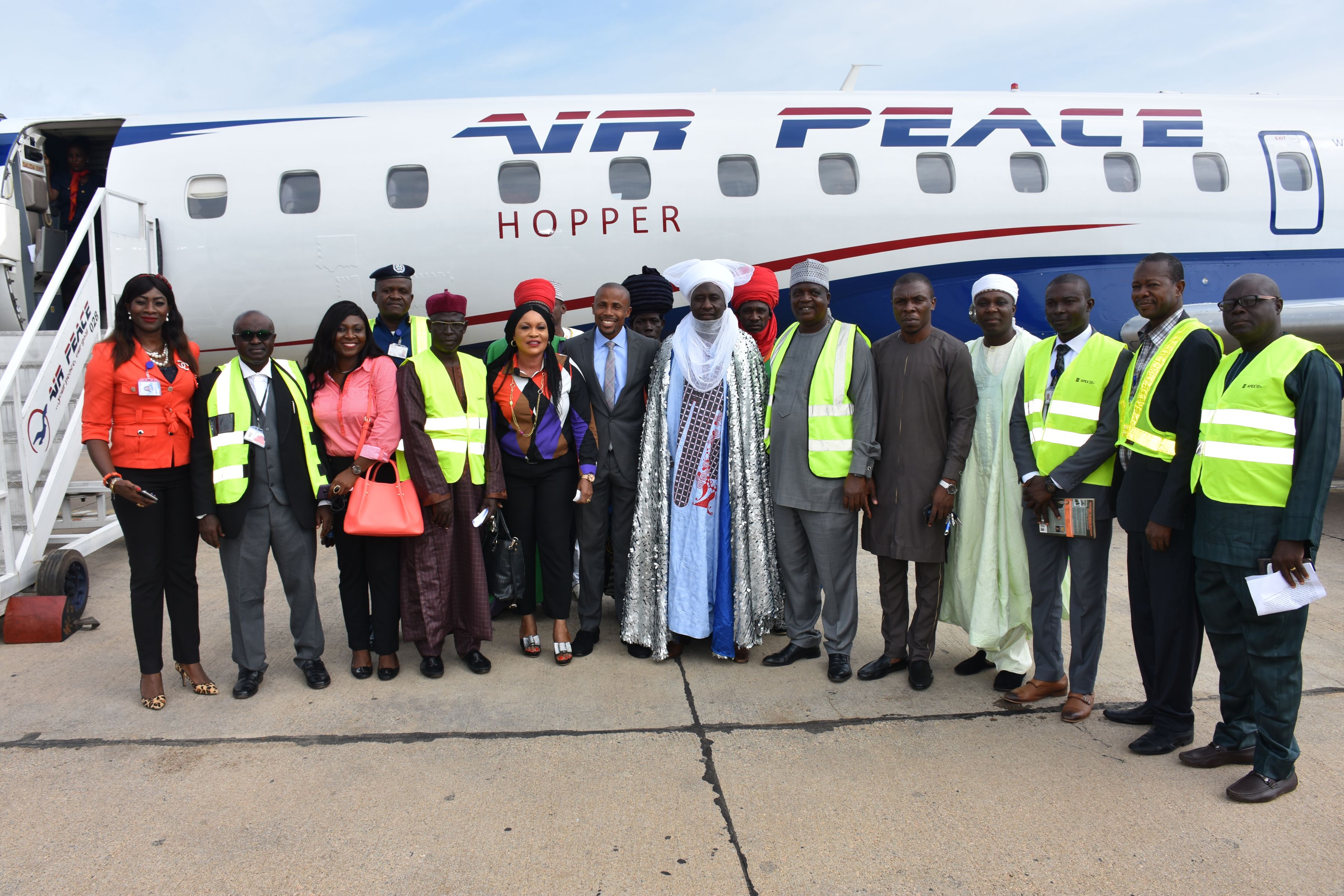 PIX 1 Representative of the Emir of Zazzau and District Head of Makera, Alhaji Shehu Tijani (7th right) flanked by Air Peace Corporate Communications Manager, Mr. Chris Iwarah (7th left), Cabin Services Manager, Florence Opia (left), Head of Monitoring and Compliance, Joy Imeli (3rd left), Assistant Customer Relations Manager, Mrs. Patricia Ebilah (6th left), Business Development Executive, Mr. Obinna Ezerioha (5th right), Acting Airport Manager, Kaduna International Airport, Mr. Jacob Ijaluwoye (6th right), Head of Operations, Kaduna International Airport, Mr. Mohammed Sadiq (5th left), Kaduna Station Manager of Skyway Aviation Handling Company Limited, Mr. Farouk Mohammed (2nd left) and others at the Kaduna International Airport during the launch of Air Peace Lagos-Kaduna service on Monday