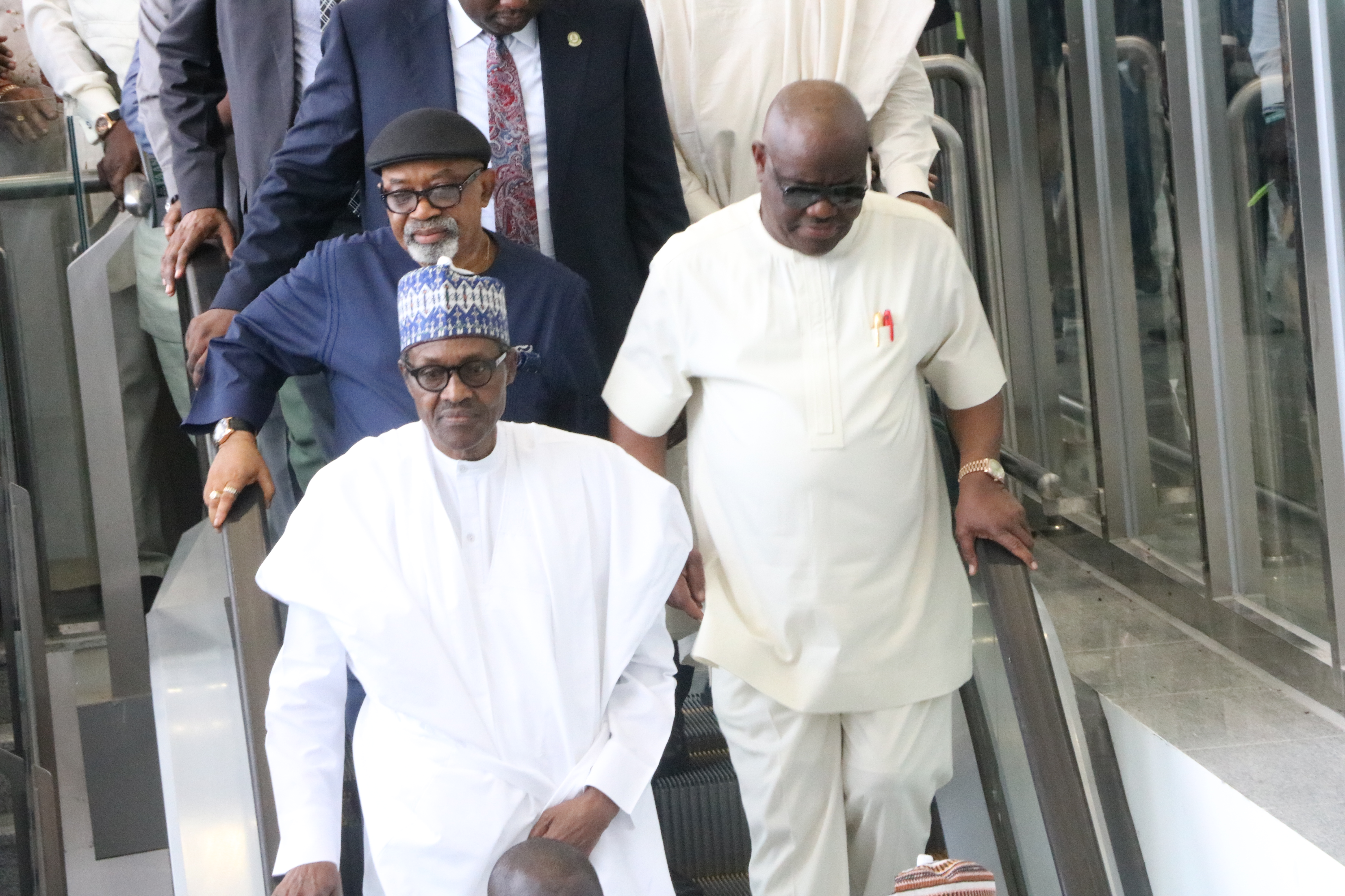 Buhari, Nwike and Minister of Labour and Productivity (behind) inspecting facilities at the new terminal.