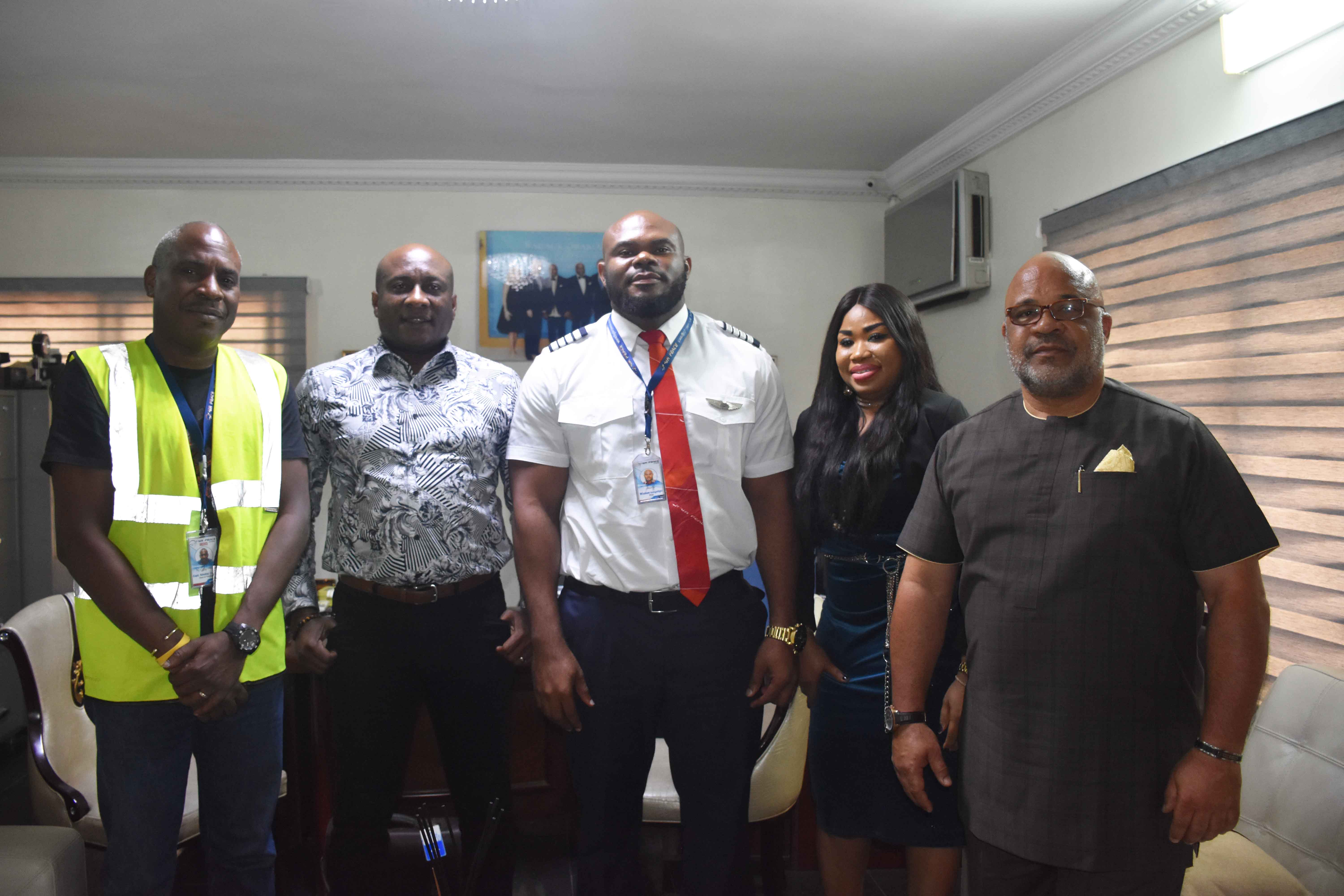 Air Peace Chairman/Chief Executive Officer, Mr. Allen Onyema (2nd left) and Chief Operating Officer, Mrs. Oluwatoyin Olajide decorating the first Emb 145 captain produced by the airline, Capt. Wisdom Isangadighi at Air Peace Corporate Headquarters in Lagos on Monday, while the Head of Training, Capt. Ndubuisi Ekwempu looks on