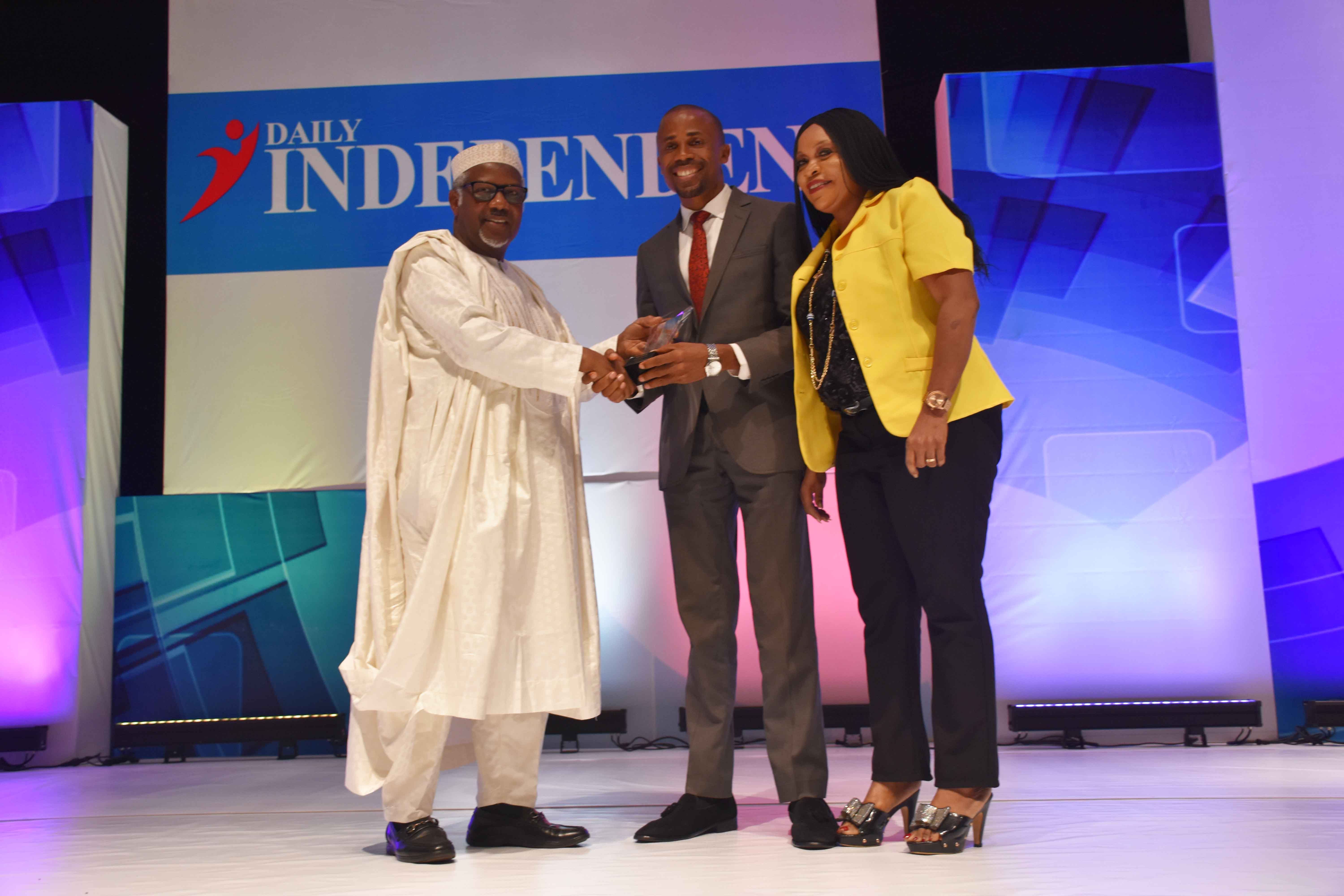 Air Peace Corporate Communications Manager, Mr. Chris Iwarah receiving the carrier’s Airline of the Year 2018 Award from the Chairman of Independent Awards 2018, Engr. Mansur Ahmed (left) during the event in Lagos on Thursday, while Air Peace Assistant Customer Relations Manager, Mrs. Patricia Ebilah looks on