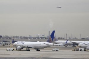 In this Wednesday, Jan. 23, 2019 file photo, United Airlines jets are seen as a plane approaches Newark Liberty International Airport, in Newark, N.J. United Airlines will woo high-fare passengers by retrofitting more than 100 planes to add more premium seats on key routes. United announced the moves Wednesday, Feb. 6, 2019. (AP Photo/Julio Cortez, File)