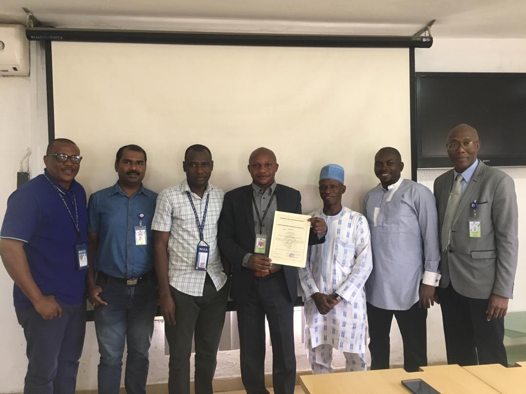 From left: Engineer Uche Nwiwu of the Nigeria Civil Aviation Authority (NCAA) , Engineer Prajo E.Narayanan, DAV-AAKY Nigeria Limited , Engineer Frank Igwe of the NCAA with CEO DAV-AAKY Nigeria Limited, Engineer Ayoola Stephen flanked by Mr. Adamu Malik, Engineer Sabruwa and Mr. Bankole Pius at the award of the Approved Maintenance Organization (AMO) Certificate at the NCAA Annex in Lagos.